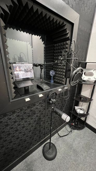 A professional recording studio with microphones and soundproofing foam.