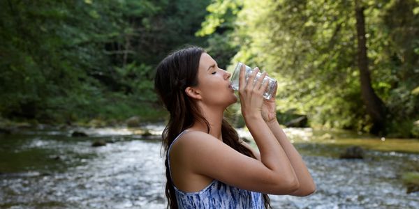Woman drinking water in nature