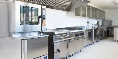 Licensed plumber fixing leaking pipe in Terrell TX home kitchen