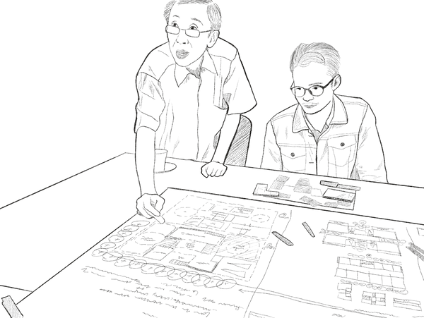 Two professionals discussing business charts at a table in an office setting.