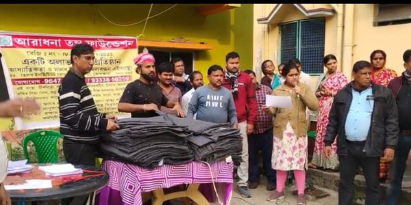 Group organizing blankets for distribution in a community event.