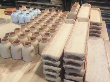 Tableware in Progress for Farmers Daughter Restaurant of Normandy Farms Hotel and Conference Center. 22" Serving Trays and hand pourers from the RIO Tableware Collection in Red Stoneware hand crafted by Nicole Dubrow Ceramics for Black 