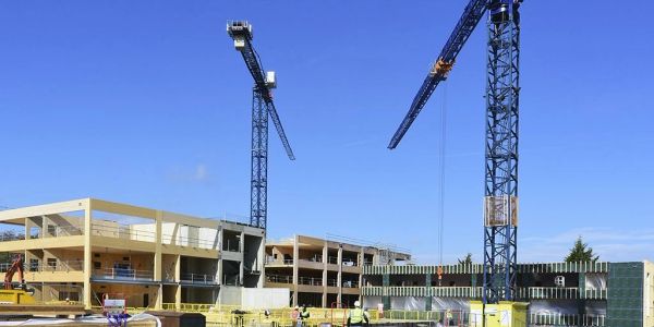 Construction site with cranes and buildings under development.