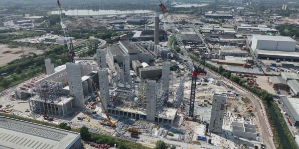 A large industrial construction site with cranes and buildings.