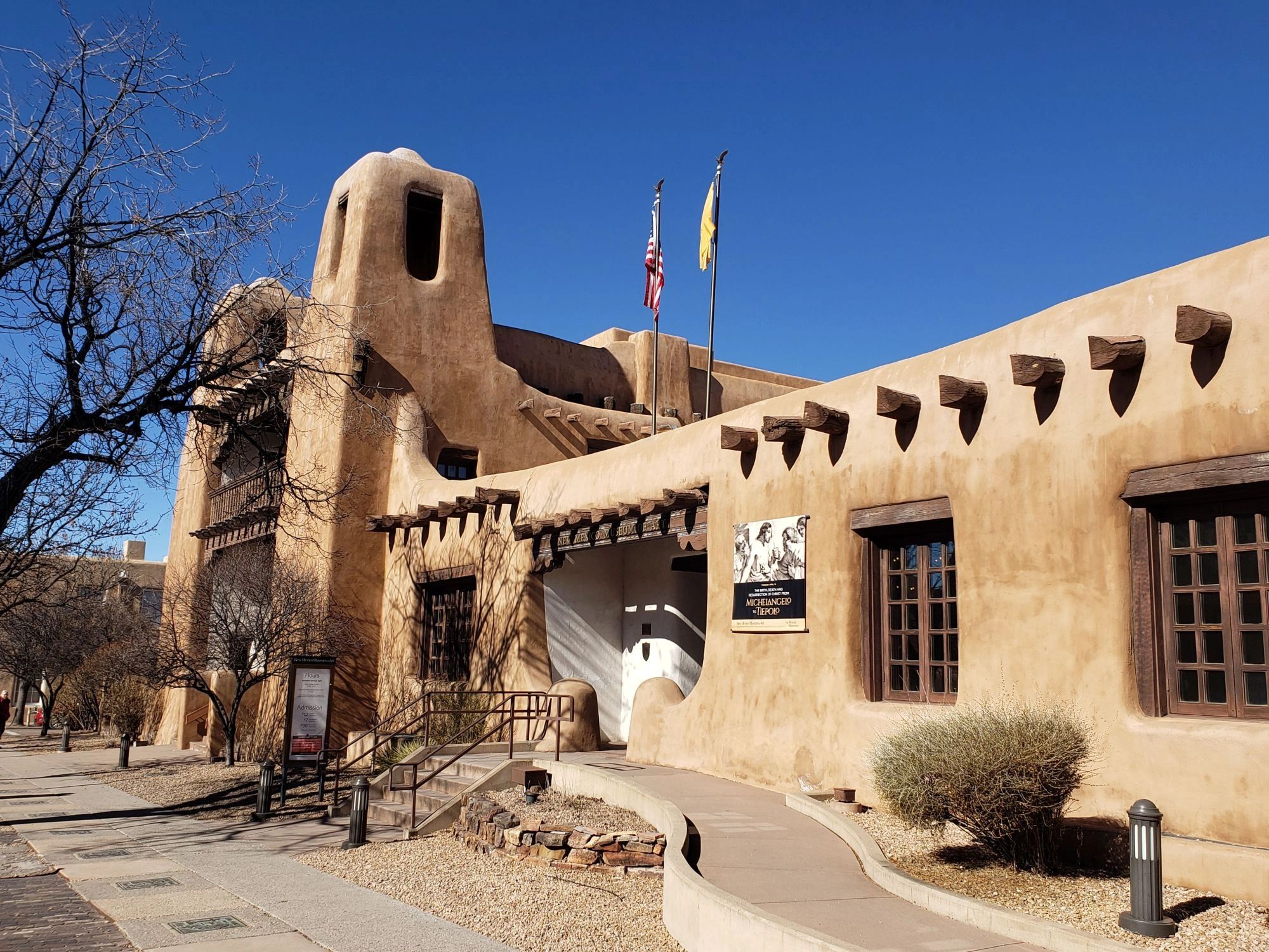 Adobe building with beams, bell towers, blue sky on your private Santa Fe Architecture Walking Tour