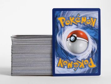 A stack of Pokémon cards with one card facing forward.