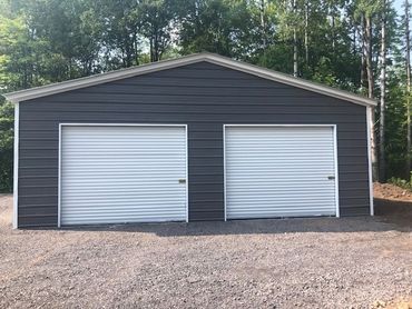 30x40x10 Gray and white prefab 2 car metal garage is low-maintenance for Central New York.