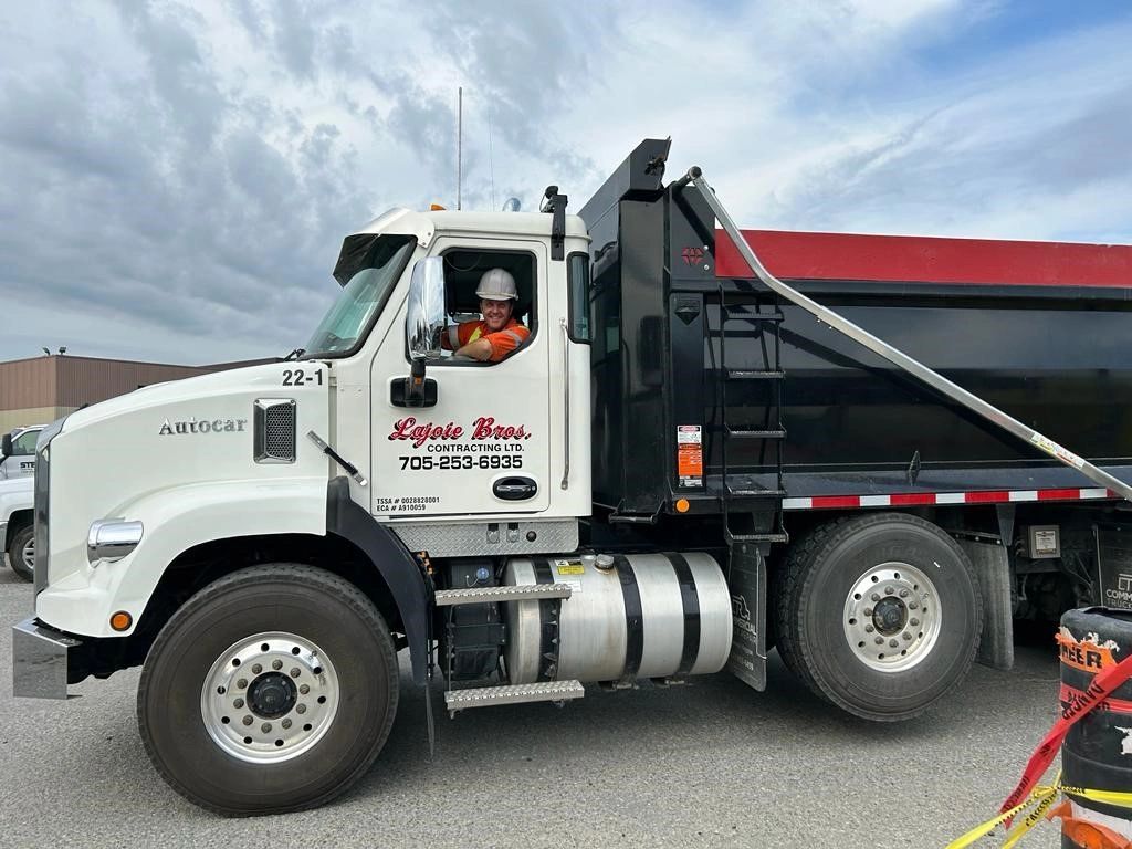 A Lajoie Bros. Contracting crew member driving a truck.