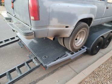 20' car trailer transporting dually truck