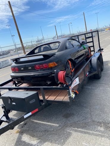 utility trailer transporting small car