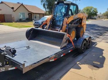 20' trailer transporting skid steer