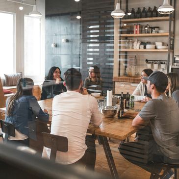 Team meeting in a modern office with casual attire.