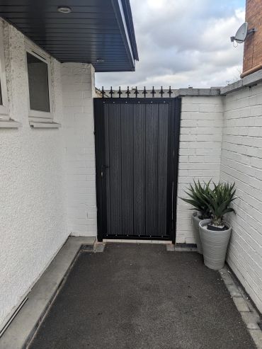 tall single composite gate with steel frame and finials