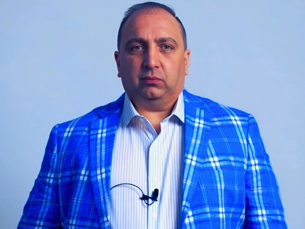 Man in a blue plaid jacket and white shirt.