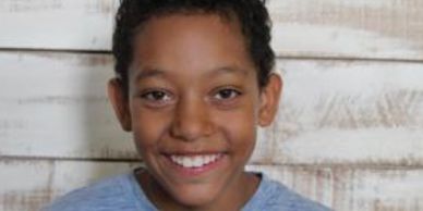 One of our Talk to the Camera Brand Ambassador Kiddos, smiling at the camera.