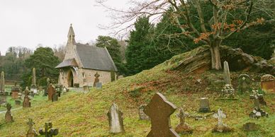 A small chapel surrounded by a graveyard with old tombstones.
