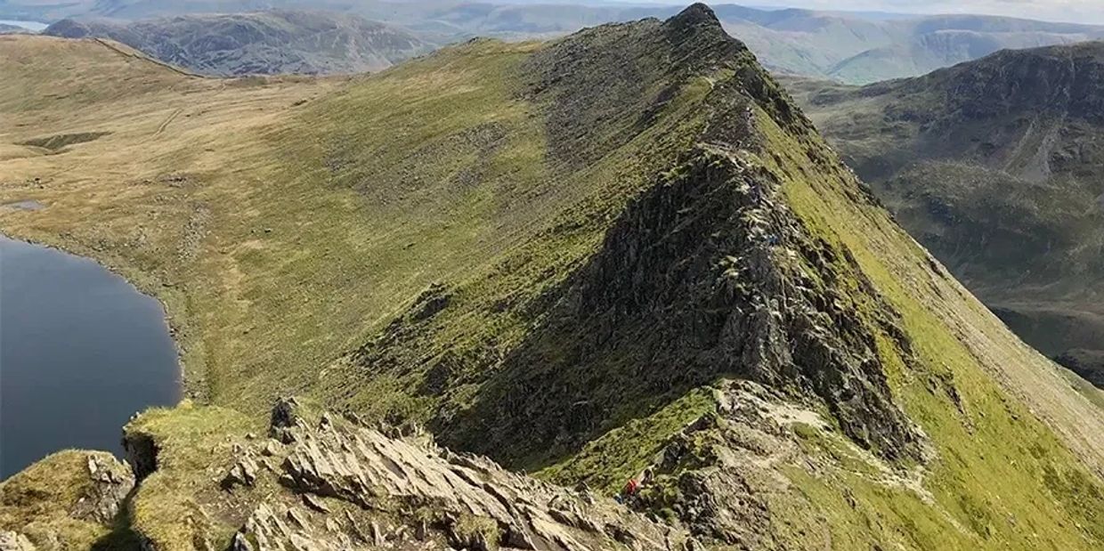 group of walkers on scafell pike with a mountain leader guide