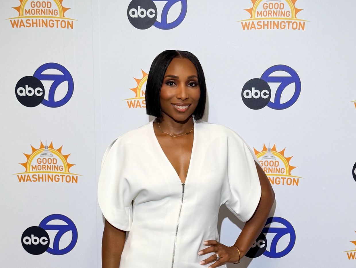 Smiling woman in white dress at Good Morning Washington event.