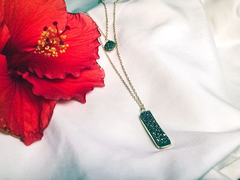 Chain necklace with red flower on fabric