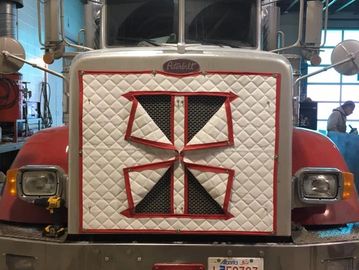 Hood cover for a semi truck. Red and White in color.