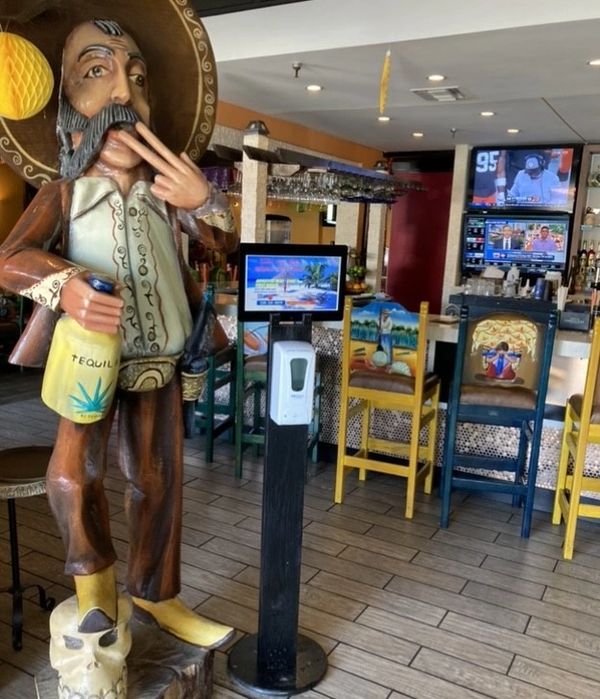 a Mexican cowboy statue with tequila bottle