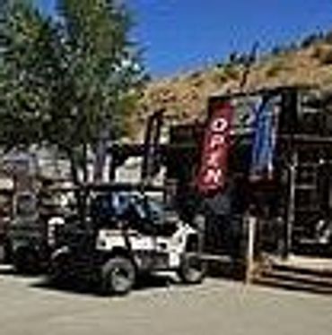 Two off-road vehicles parked outside a Somethings Brewing Coffee Shop.