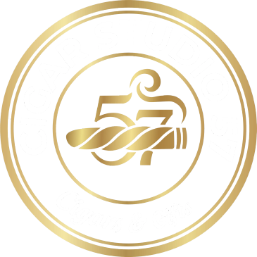 Gold and white circular cigar studio logo with number 57.