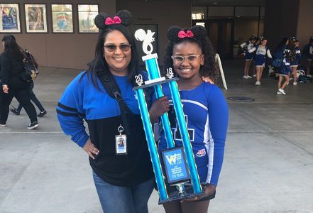 Mom and daughter holding 1st place trophy for 2018 cheer competition