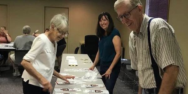 A group of people organizing papers on a table.