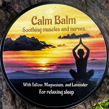 Calm Balm container with sunset and yoga silhouette, placed on tree bark and moss.