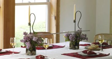 Spring Tabletop centerpiece. Wine Chime Toasting Bar in glass vase with river rocks and Lilacs 