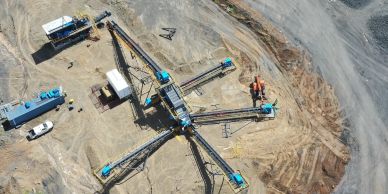 Aerial view of a mining site with machinery and vehicles.