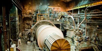 Interior of an industrial cement or mining facility with large machinery.