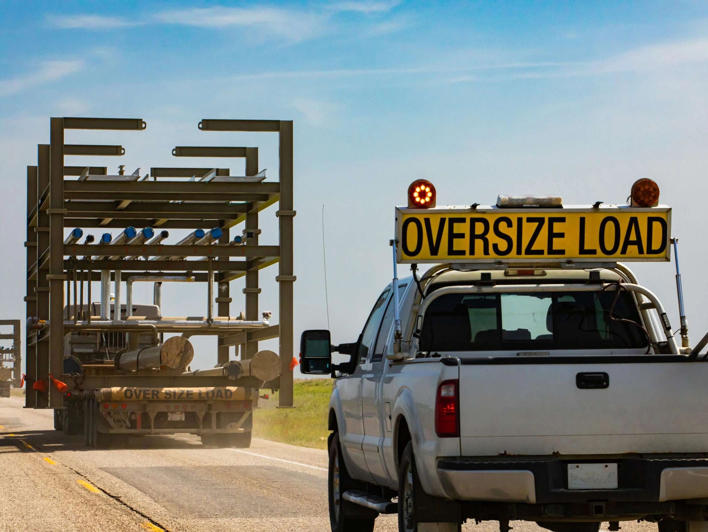 heavy haul truck transporting oversized over-dimensional equipment cargo; flatbed; step deck; RGN