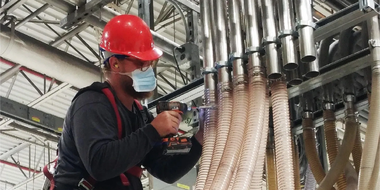 Electrical technician working with material piping