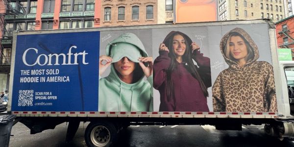 Truck advertisement for Comfrt hoodies with diverse models.
