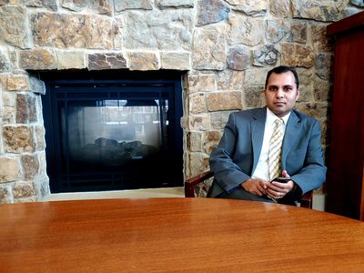 Desk photo of Neeraj Shah, Esq., MBA, CPA. Neeraj Shah is a CPA and attorney.