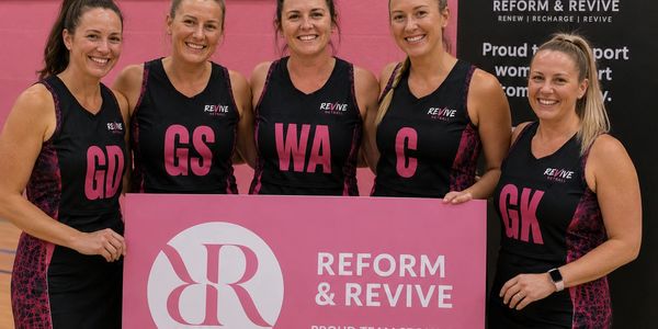 Five women in sports uniforms hold a Reform & Revive sign.