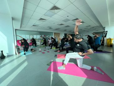 Group yoga session in a bright studio.