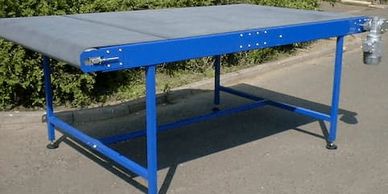 A light duty automotive press conveyor utilising cut resistant belting, to transport parts from the 
