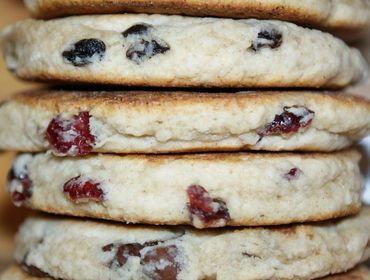 A stack of Welsh Cakes that includes Chocolate Chip, Cranberry and Currant. 