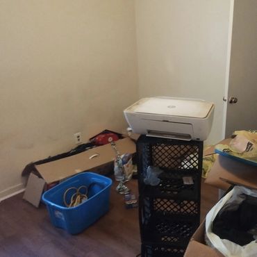 Bedroom before cleaning with clutter and items left behind.