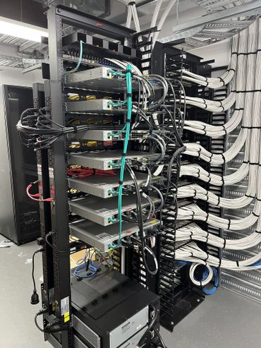 Organized server rack with neatly arranged cables and networking equipment.