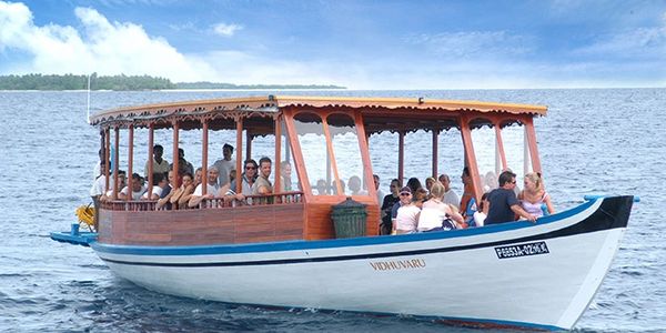 Tourists on a wooden boat enjoying a sea ride.