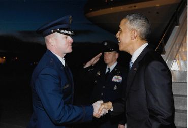 Retired Brigadier General Carl Buhler greets President Obama at Hill AFB, Utah while the OO-ALC/CC.