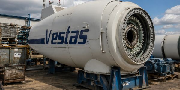 A large Vestas wind turbine nacelle on a stand outdoors.