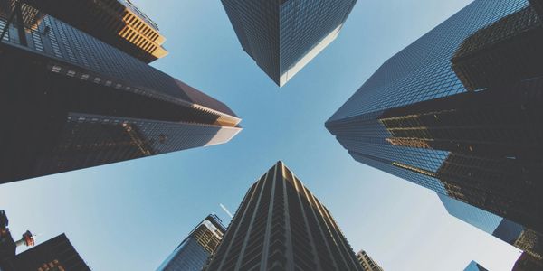View of skyscrapers from below against a blue sky.