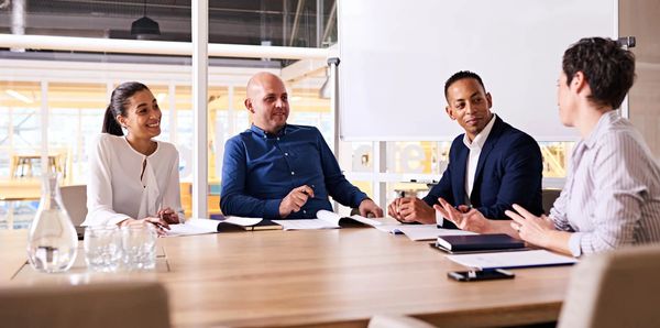 People around a table in facilitation conversation