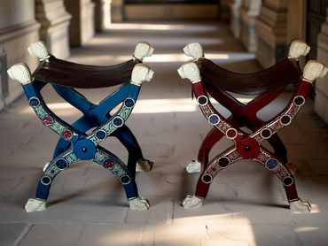 Sella curulis inspired chairs built for Norwich Castle, with carved faux ivory feet and heads.