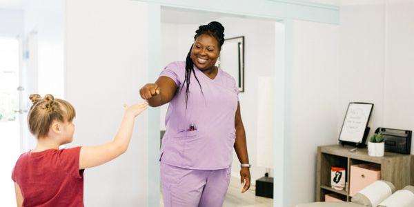 Our chiropractor talking with a pediatric chiropractic patient after an adjustment.